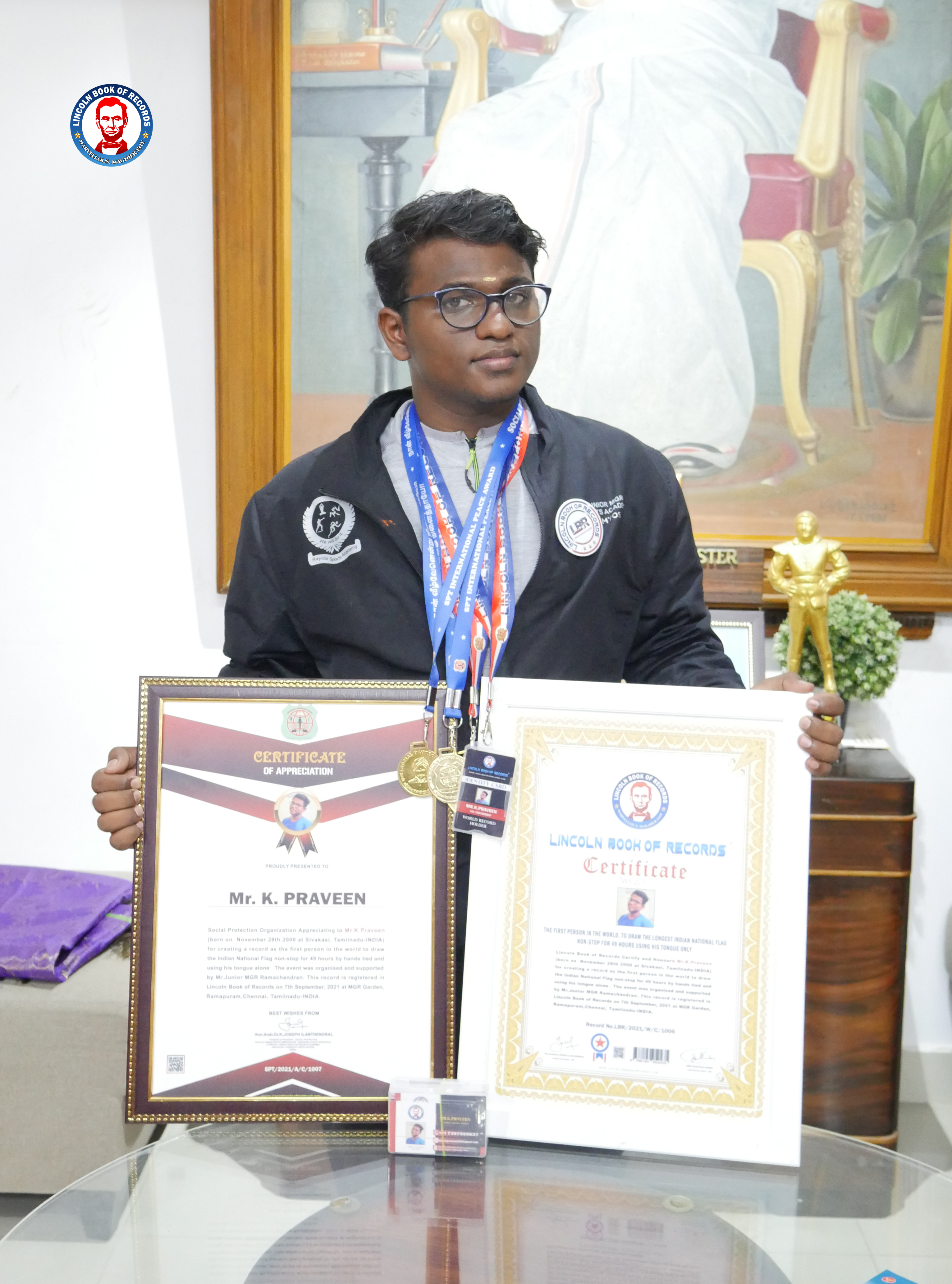 THE FIRST PERSON IN THE WORLD, TO DRAW THE LONGEST INDIAN NATIONAL FLAG  NON-STOP FOR 49 HOURS USING HIS TONGUE ONLY