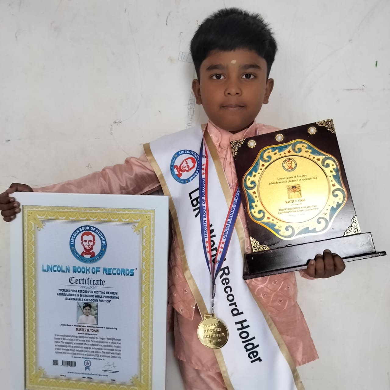 WORLD'S FIRST RECORD FOR RECITING MAXIMUM ABBREVIATIONS IN 60 SECONDS WHILE PERFORMING SILAMBAM IN A KNEE·DOWN POSITION”