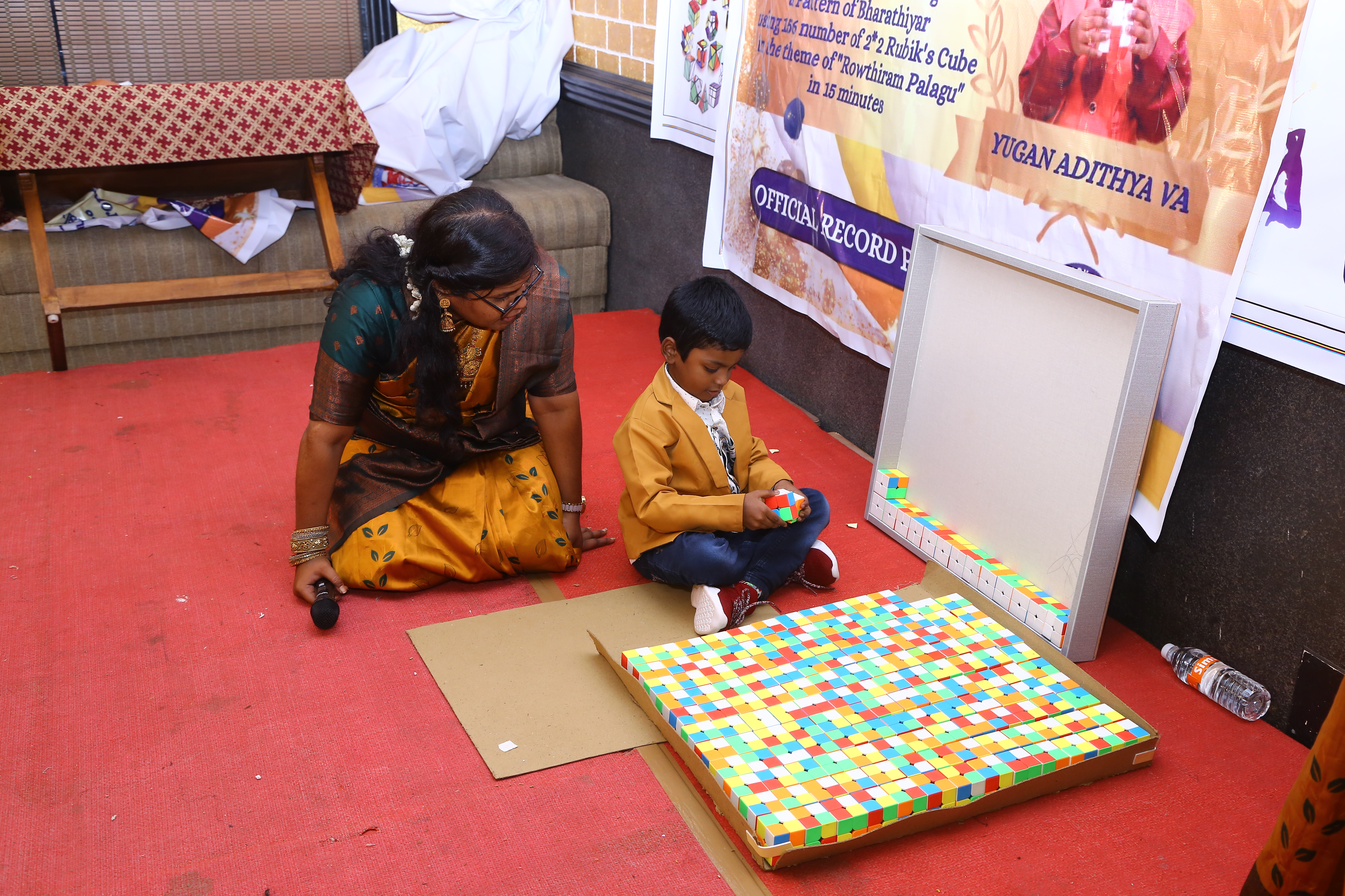 World record by arranging 156 number of 2*2 Rubik's Cube in the   formation of Bharathiyar 's face under the theme of "ROWTHIRAM PAZHAGU"  by reciting Bharathiyar 's Puthiya Aathichudi SIMULTANEOUSLy in least time.