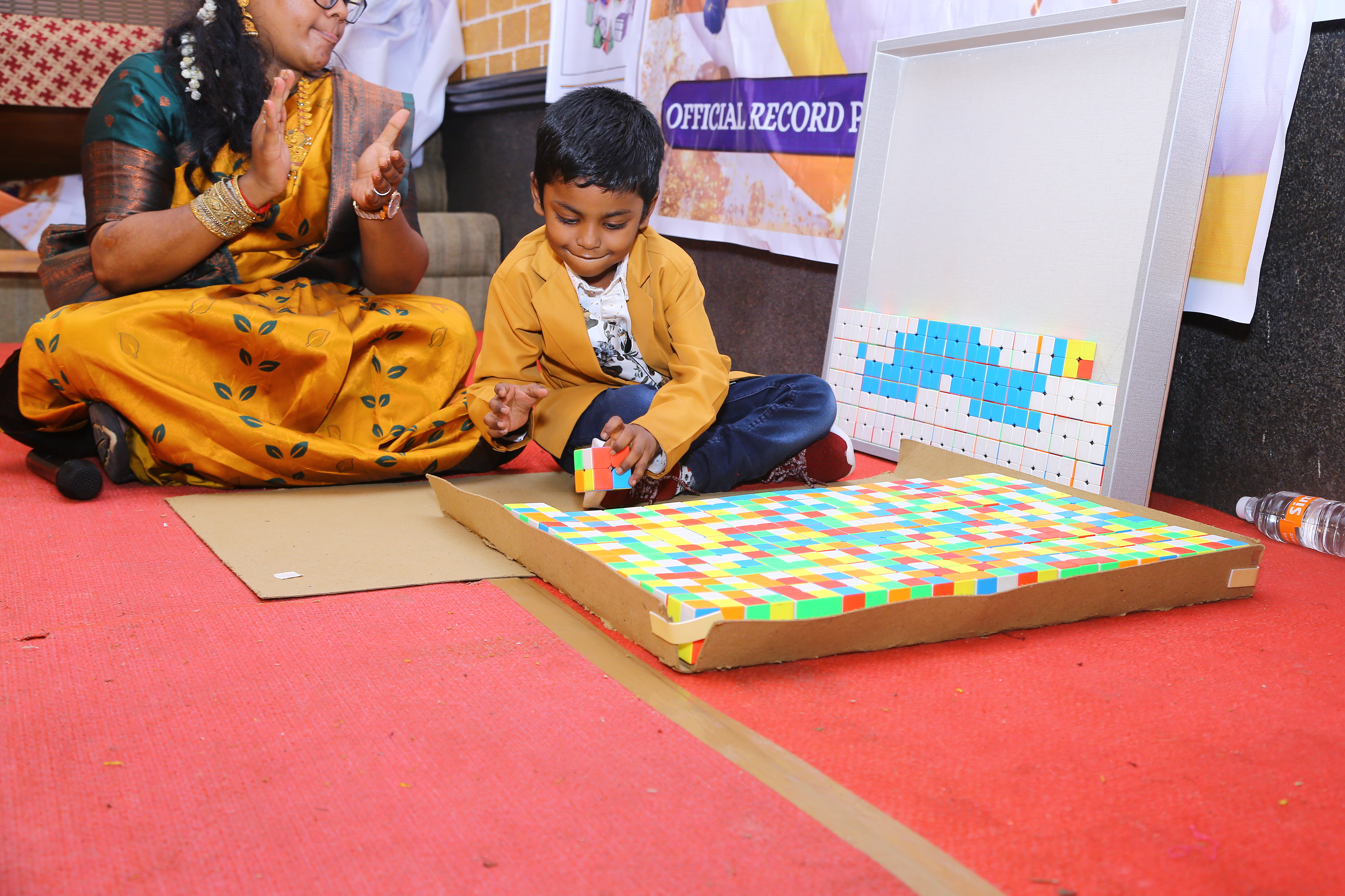 World record by arranging 156 number of 2*2 Rubik's Cube in the   formation of Bharathiyar 's face under the theme of "ROWTHIRAM PAZHAGU"  by reciting Bharathiyar 's Puthiya Aathichudi SIMULTANEOUSLy in least time.