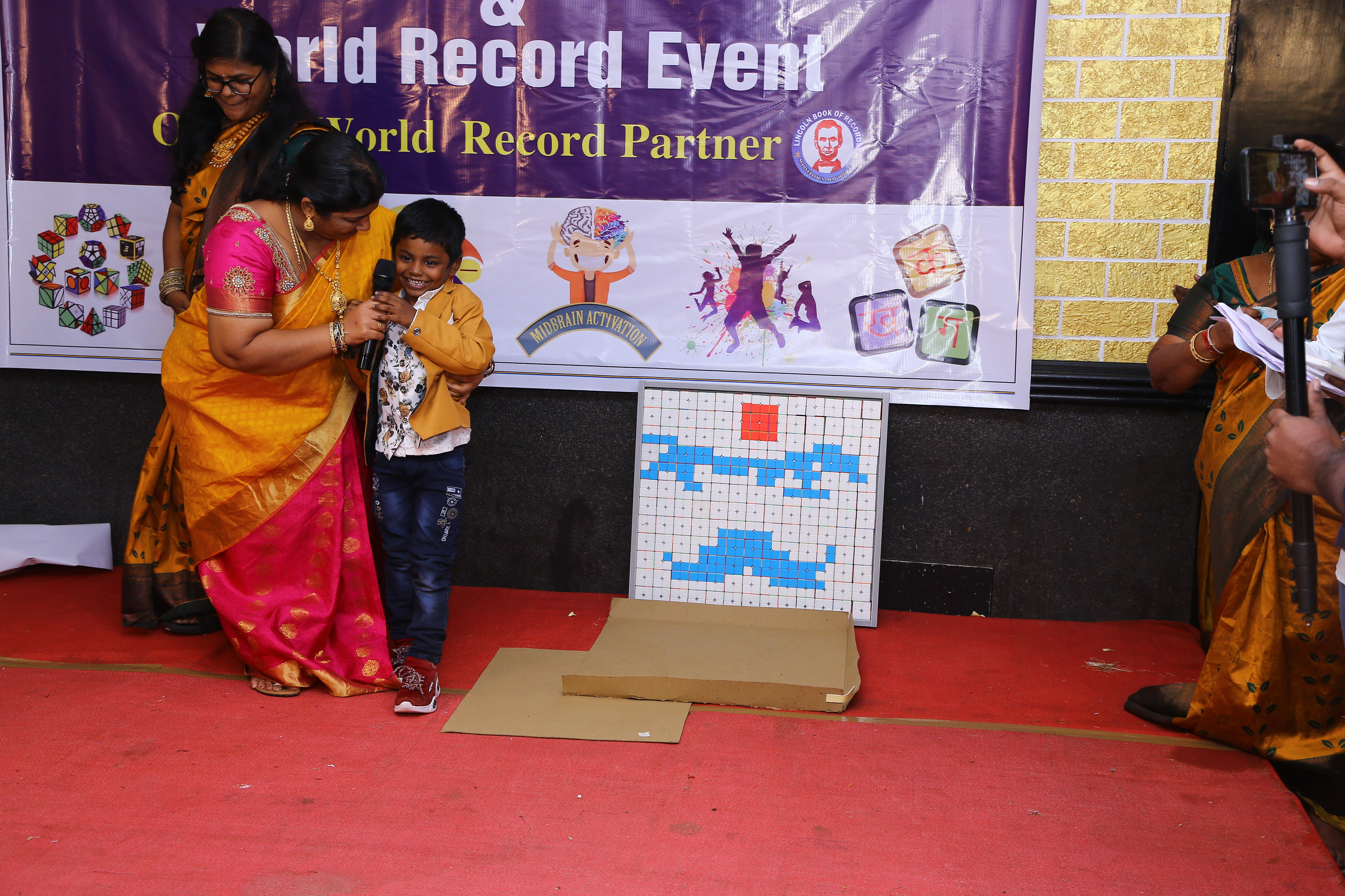 World record by arranging 156 number of 2*2 Rubik's Cube in the   formation of Bharathiyar 's face under the theme of "ROWTHIRAM PAZHAGU"  by reciting Bharathiyar 's Puthiya Aathichudi SIMULTANEOUSLy in least time.