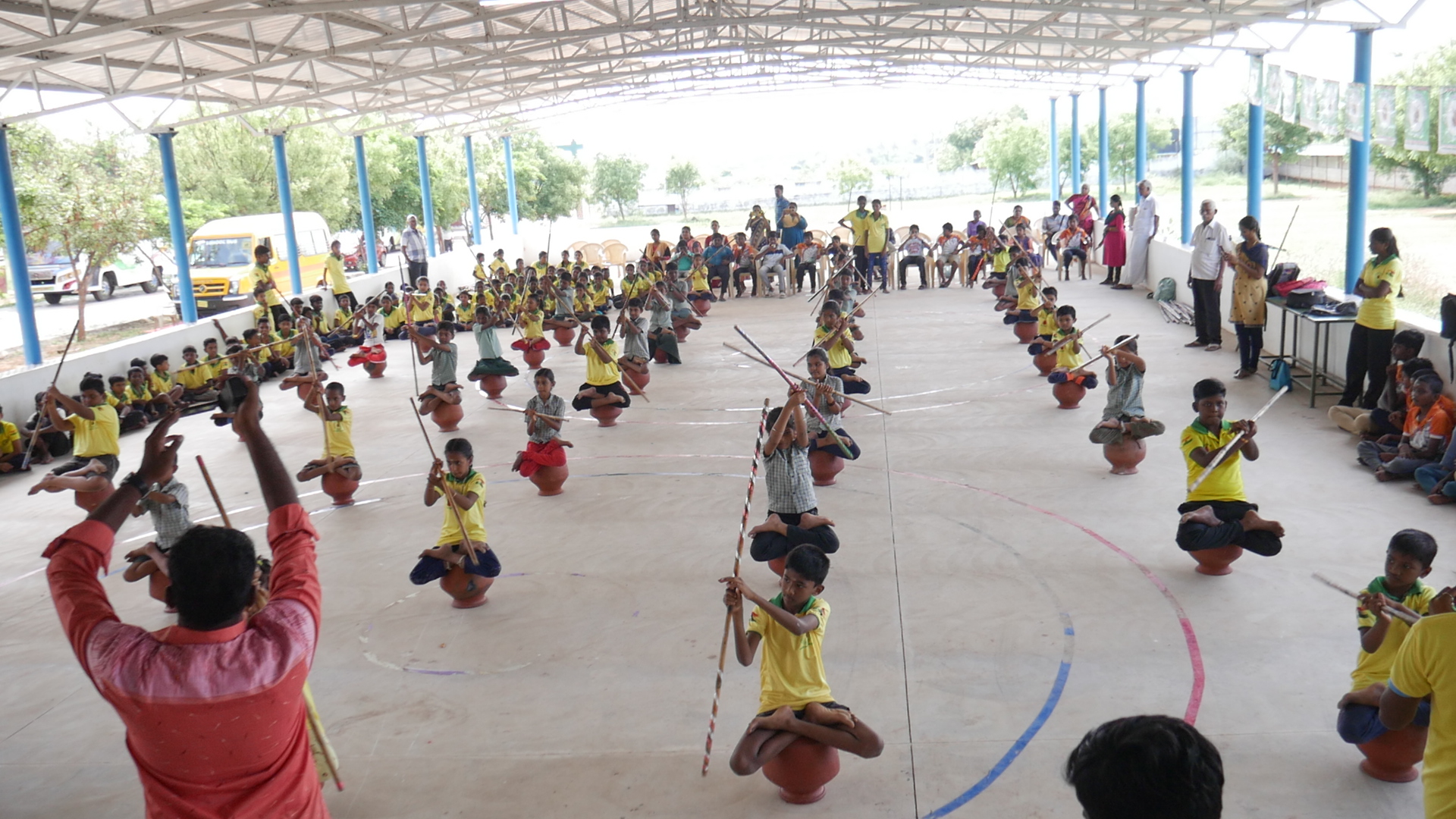 World record performance of 30 minutes Silambam  circling in Padmasana yogasan posture on mud pot.