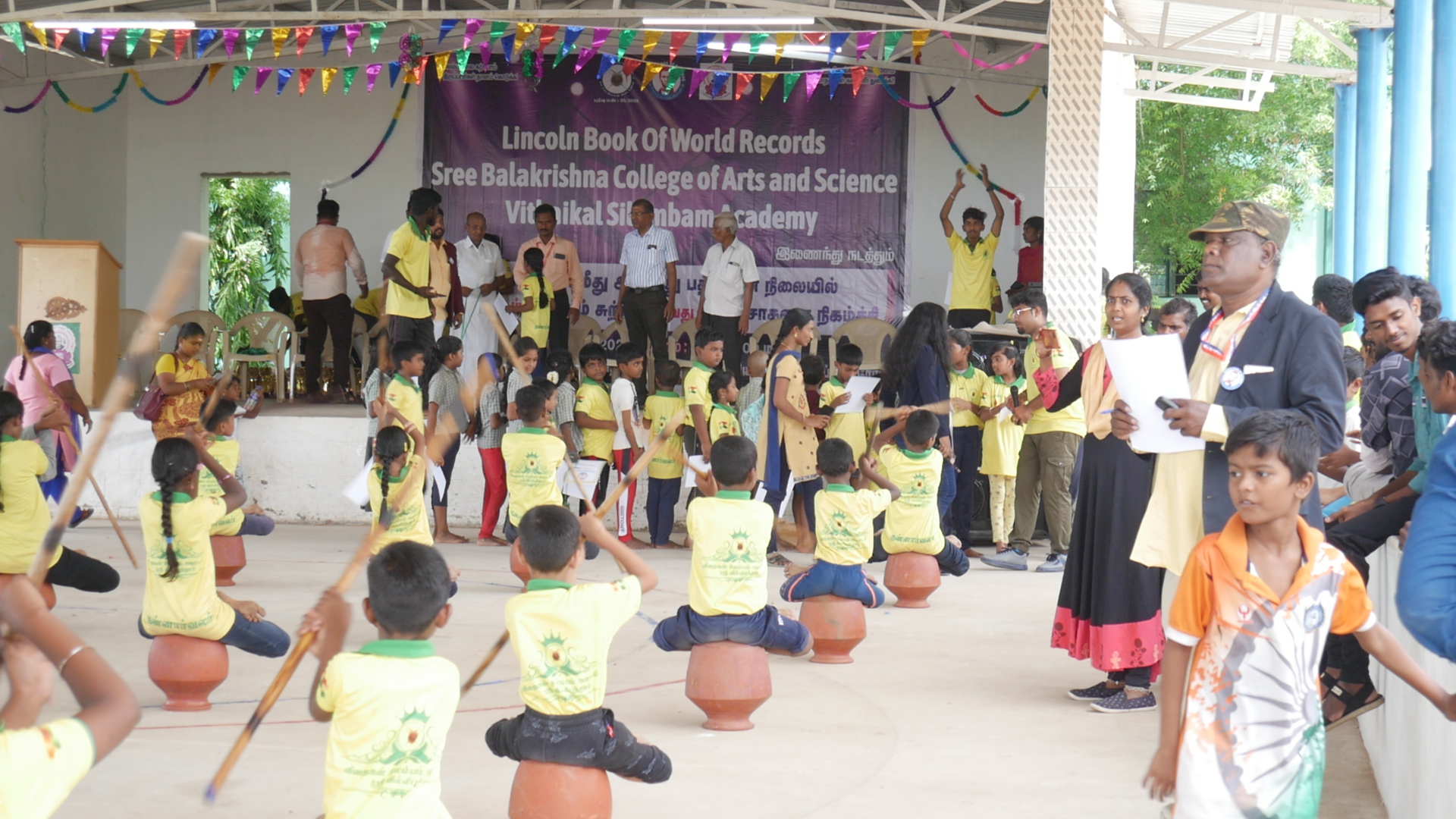 World record performance of 30 minutes Silambam  circling in Padmasana yogasan posture on mud pot.