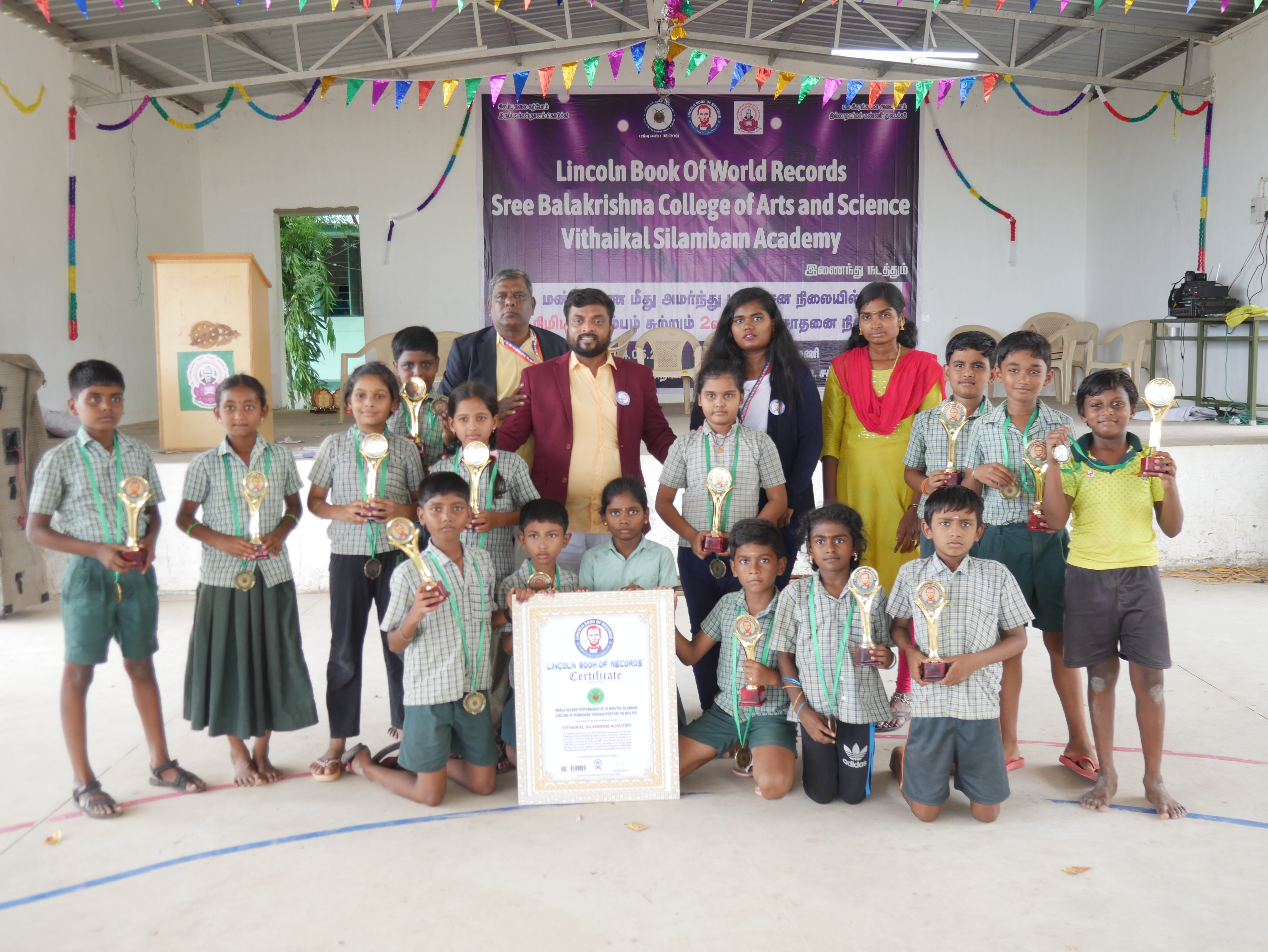 World record performance of 30 minutes Silambam  circling in Padmasana yogasan posture on mud pot.